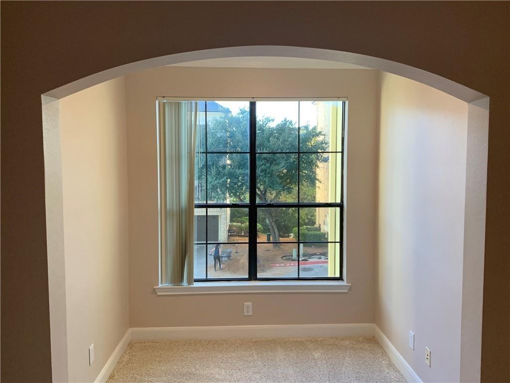 7701 Rialto Boulevard, Unit 1222 Austin, TX 78735 - Photo 5 of 14 An inviting archway frames a window that overlooks a mature tree and well-maintained grounds.
