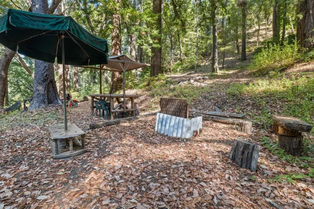 a view of a patio with table and chairs under an umbrella