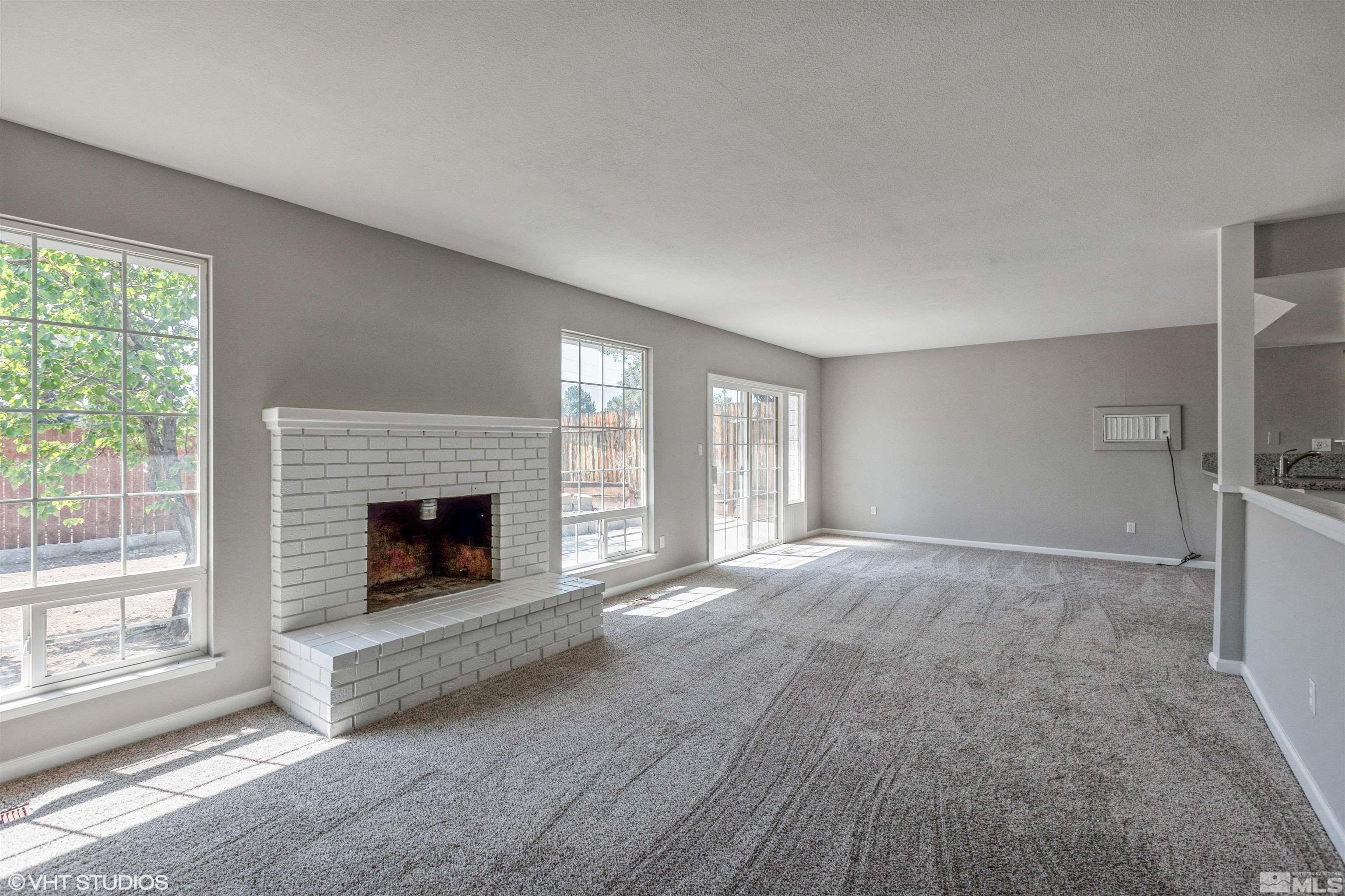 1930 Stardust Street Reno, NV 89503 - Photo 2 of 15 a view of a livingroom with a fireplace and window