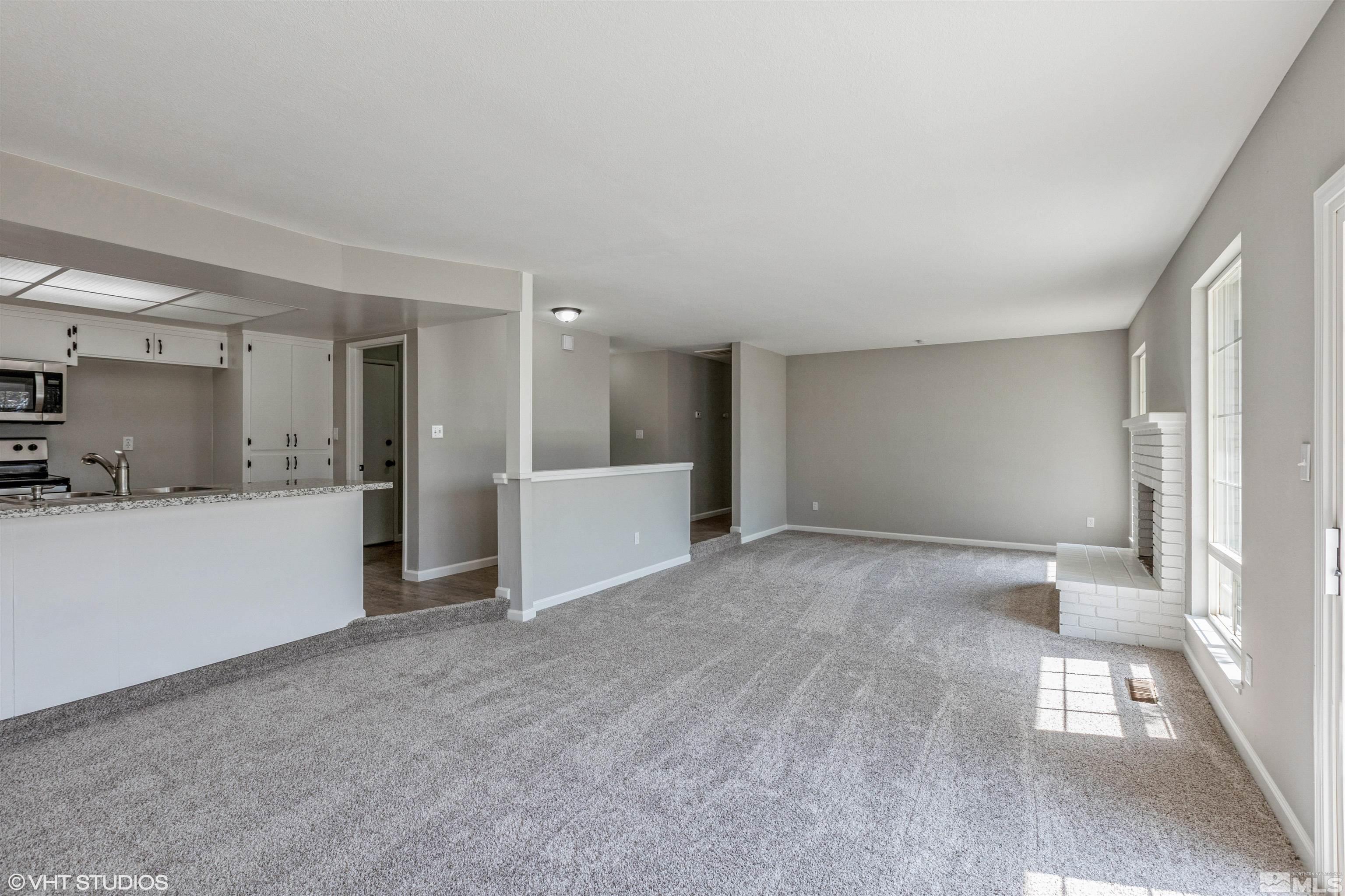 1930 Stardust Street Reno, NV 89503 - Photo 3 of 15 a view of a big room with wooden floor and windows
