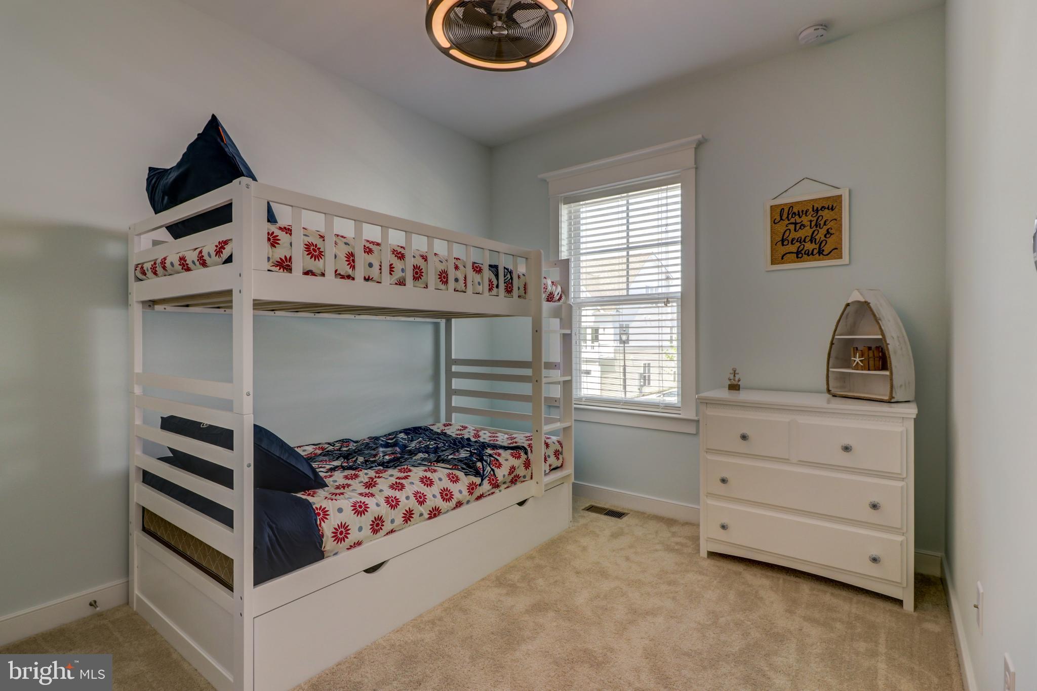 29805 Striper Harbor, Unit C3 Rehoboth Beach, DE 19971 - Photo 13 of 35 a bedroom with a bed and a dresser