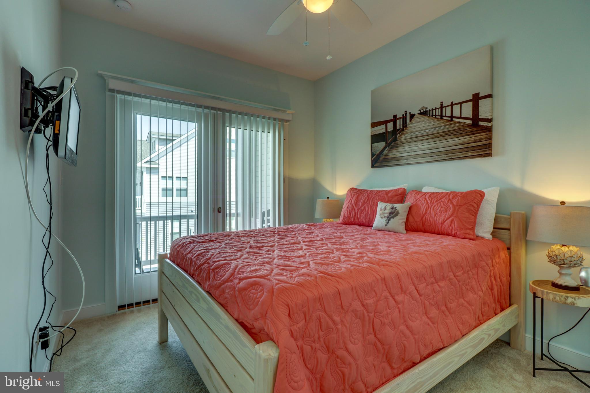 29805 Striper Harbor, Unit C3 Rehoboth Beach, DE 19971 - Photo 14 of 35 a bed sitting in a bedroom next to a window