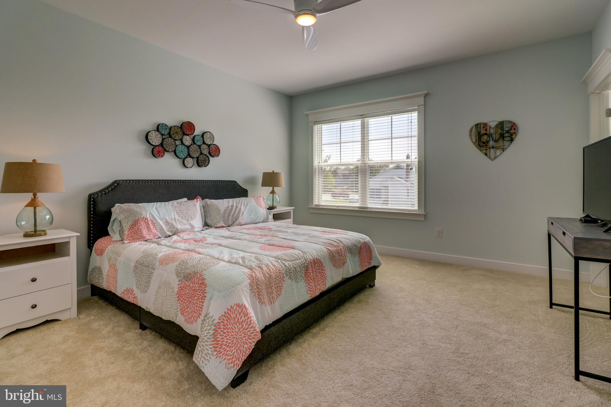 29805 Striper Harbor, Unit C3 Rehoboth Beach, DE 19971 - Photo 18 of 35 a bedroom with a bed and a flat screen tv