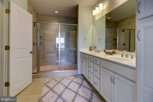 a bathroom with a double vanity sink and a mirror