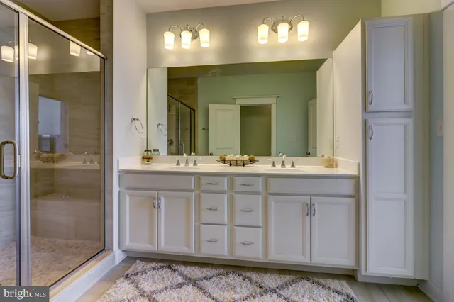 a bathroom with a double vanity sink and a mirror