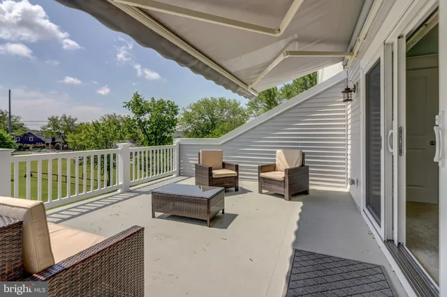 a view of roof deck with couches and potted plant