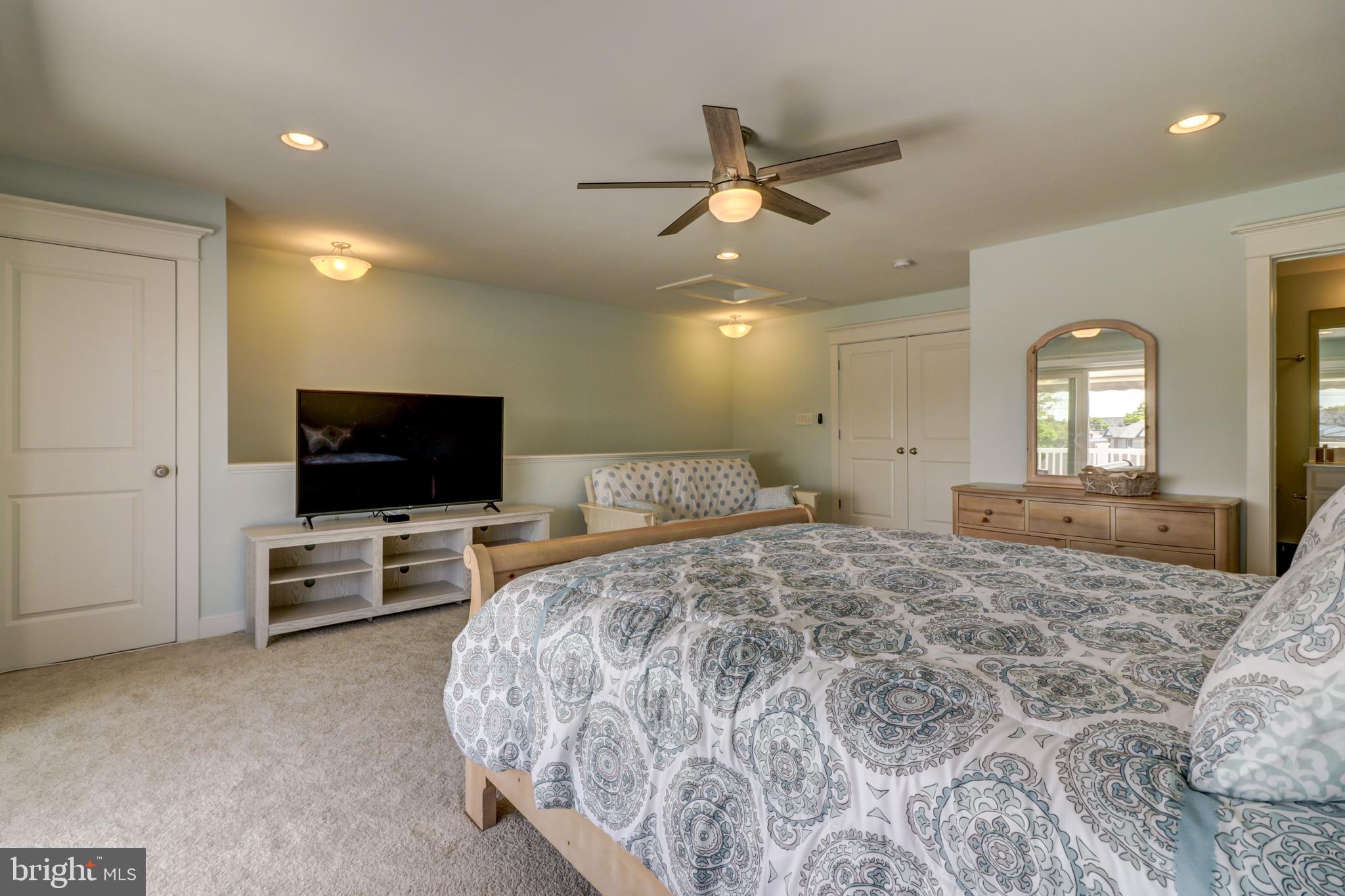 29805 Striper Harbor, Unit C3 Rehoboth Beach, DE 19971 - Photo 27 of 35 a bedroom with a bed and a flat screen tv