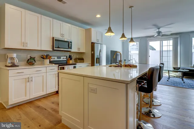 a kitchen with sink cabinets and wooden floor
