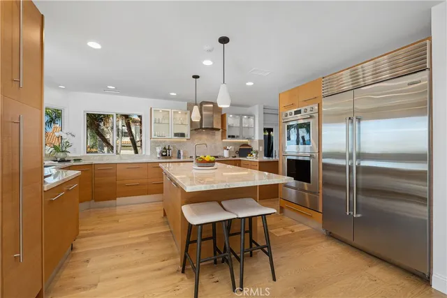 a large kitchen with kitchen island granite countertop lots of counter top space and stainless steel appliances