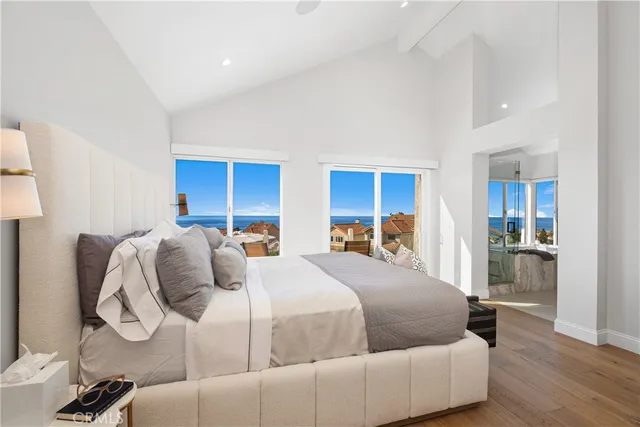 a bedroom with a bed and a view of kitchen