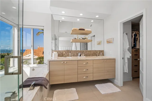 a spacious bathroom with a granite countertop sink and a mirror