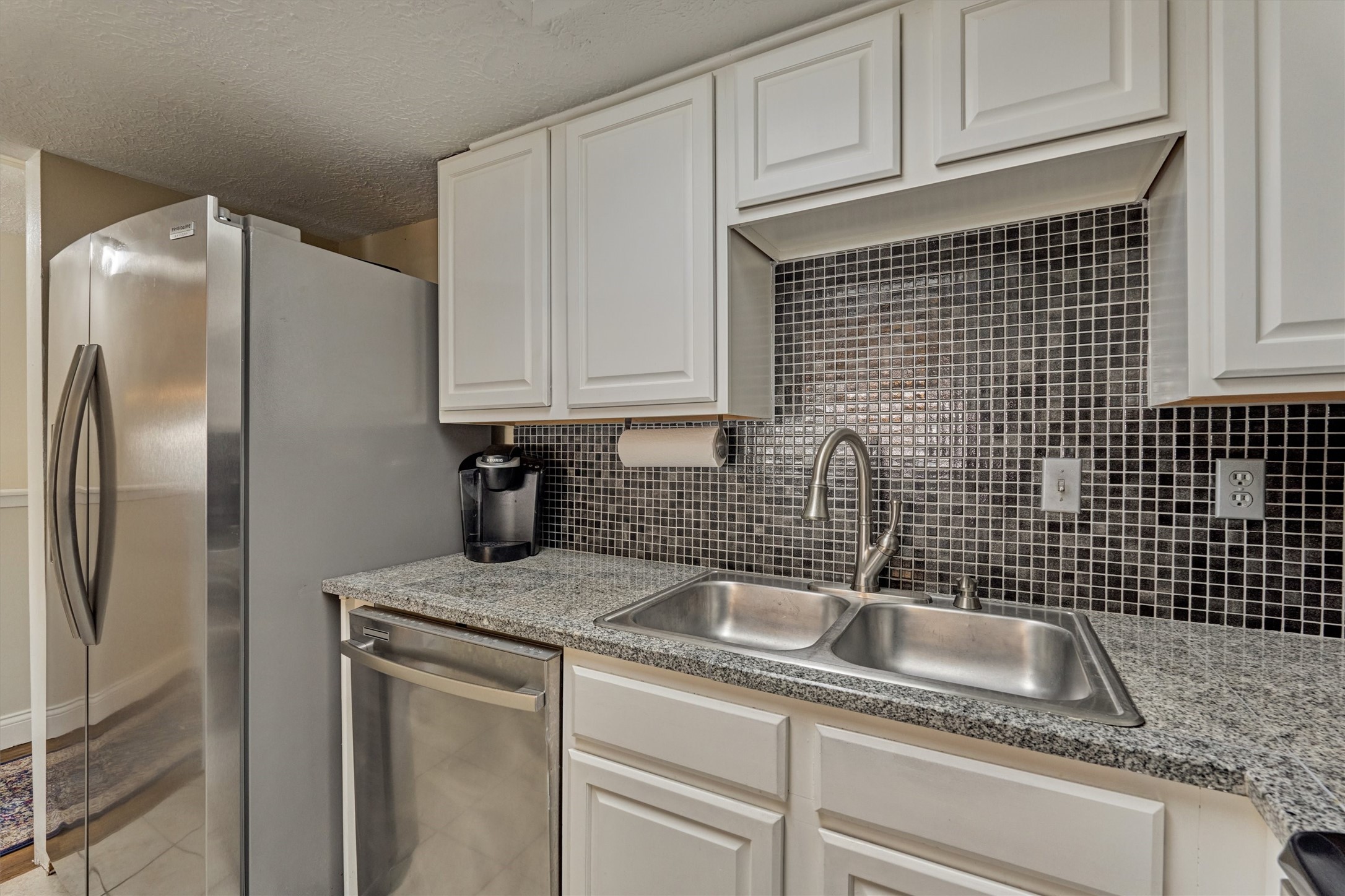 39 Regency Point Conroe, TX 77356 - Photo 23 of 44 a kitchen with a sink cabinets and refrigerator