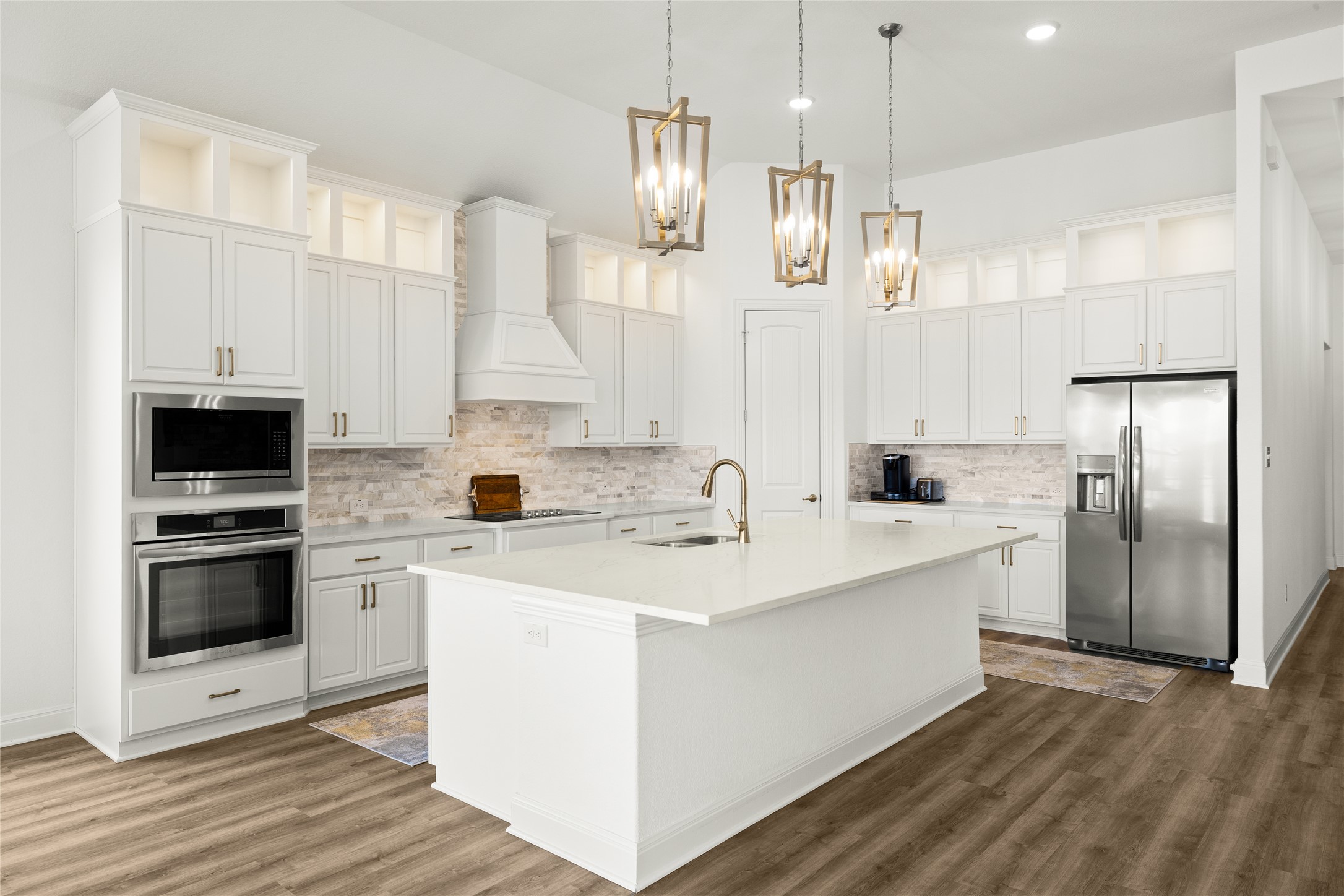 101 Bosco Road Hutto, TX 78634 - Photo 12 of 34 a kitchen with stainless steel appliances a stove refrigerator sink and cabinets