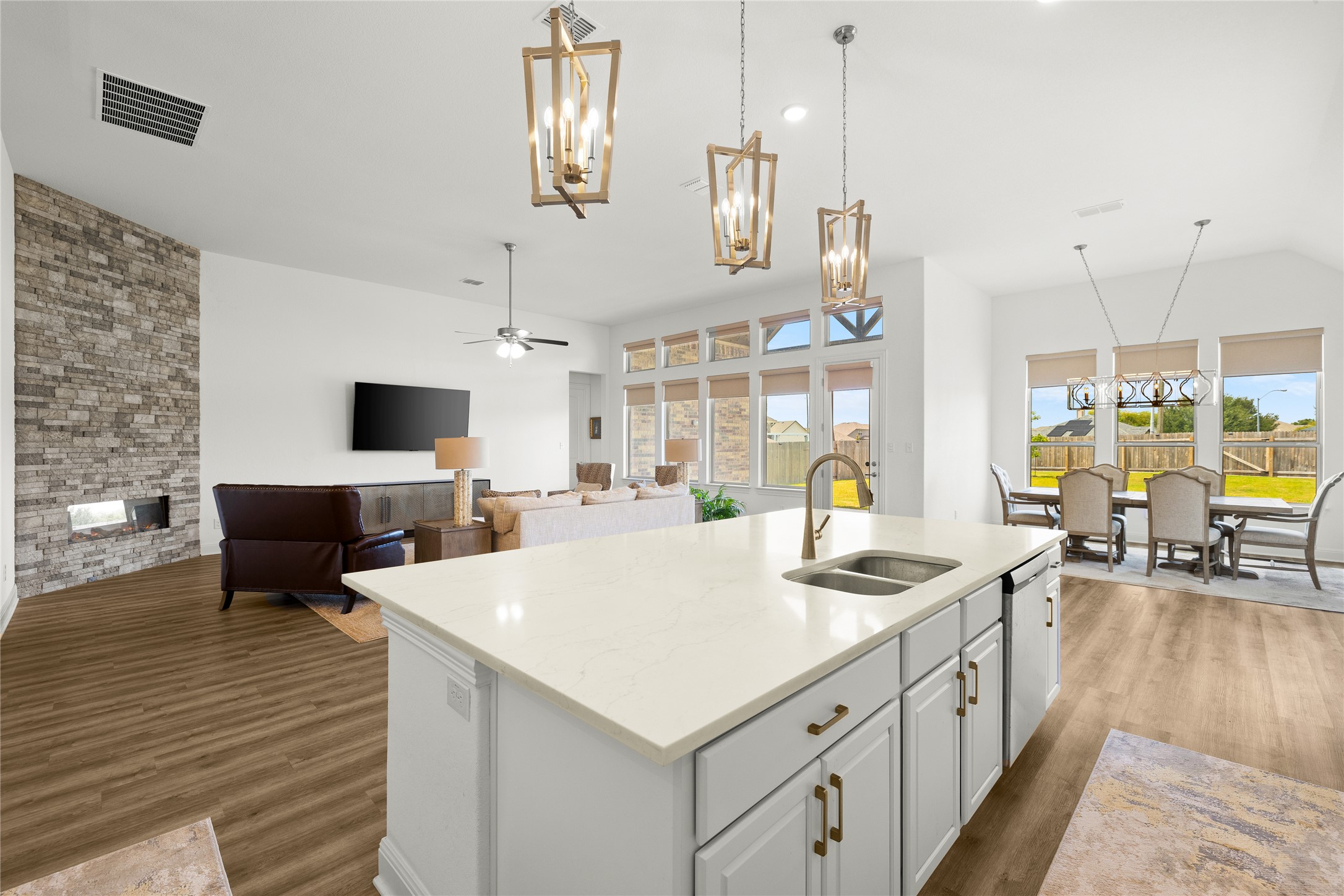 101 Bosco Road Hutto, TX 78634 - Photo 14 of 34 a kitchen with stainless steel appliances kitchen island granite countertop a sink and a stove