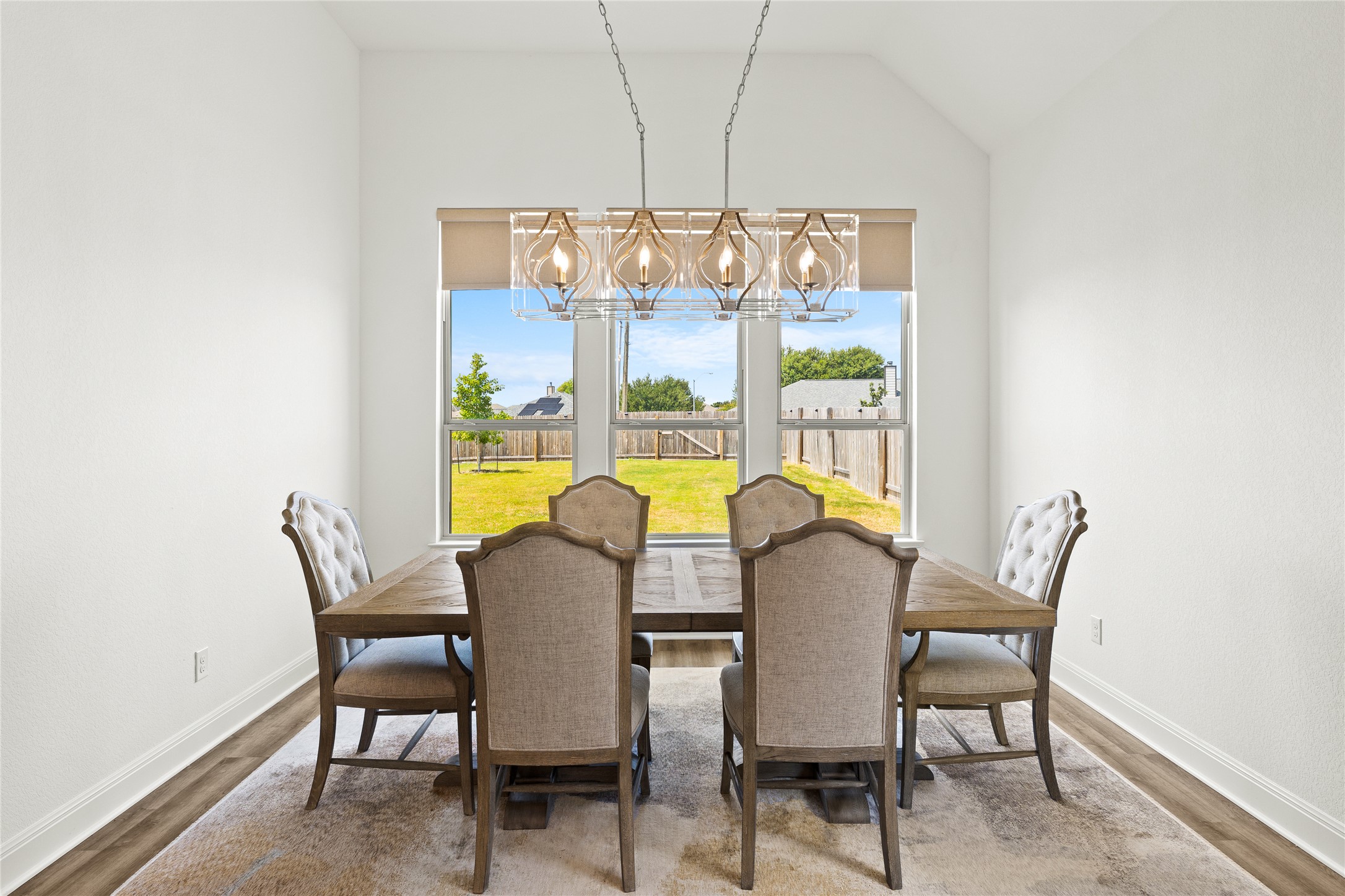 101 Bosco Road Hutto, TX 78634 - Photo 15 of 34 a view of a dining room with furniture a chandelier and wooden floor