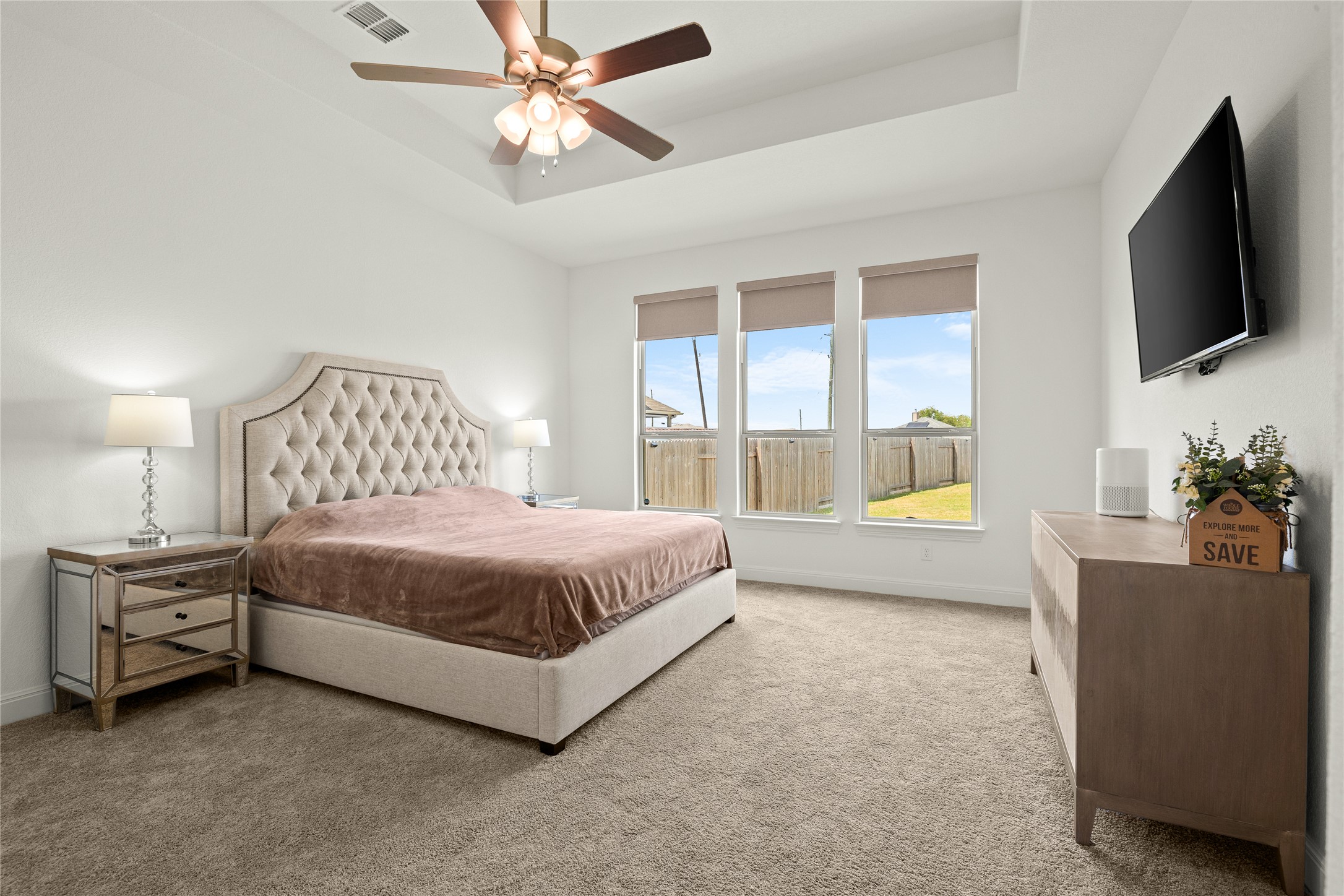 101 Bosco Road Hutto, TX 78634 - Photo 17 of 34 a spacious bedroom with a bed and a flat screen tv