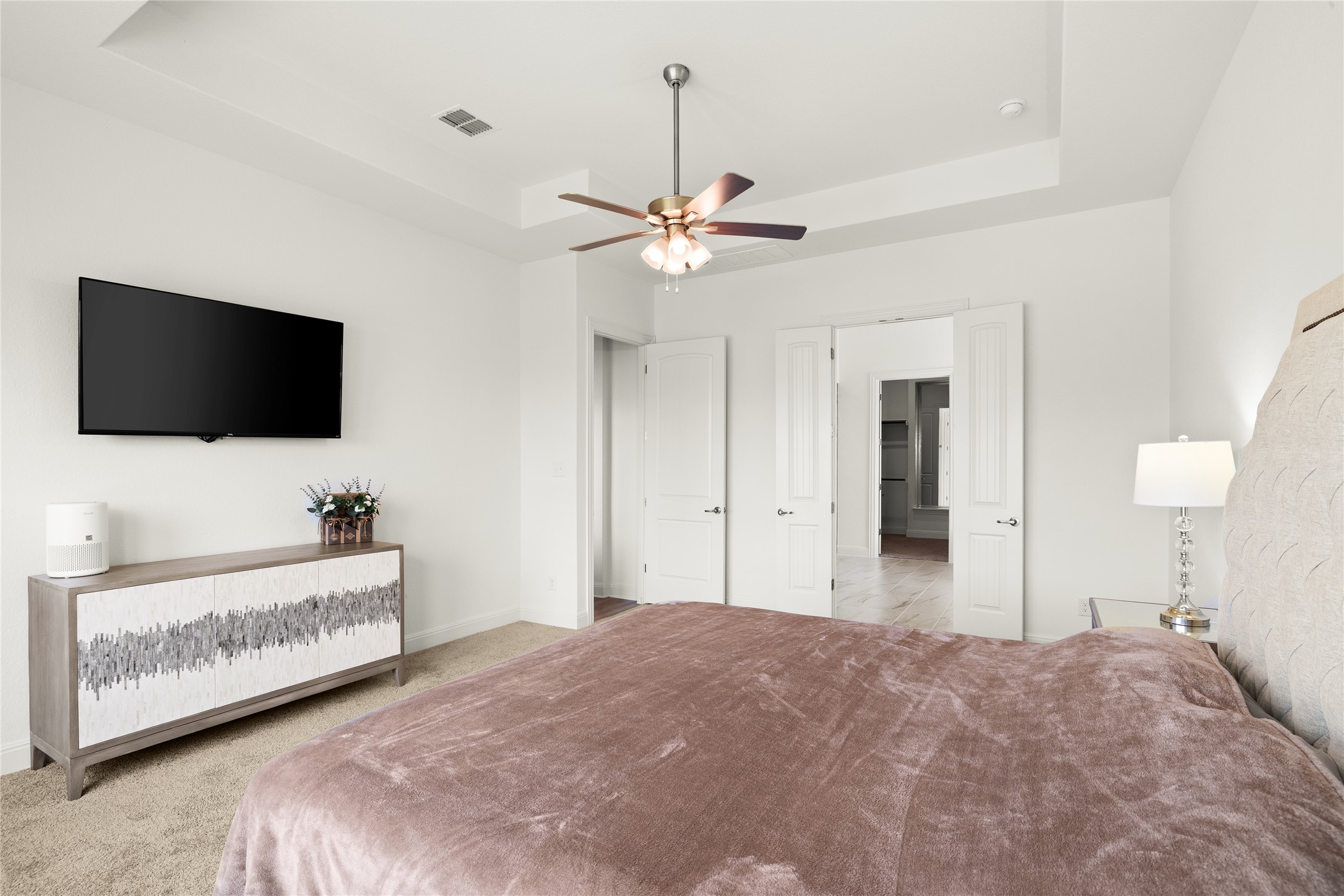 101 Bosco Road Hutto, TX 78634 - Photo 18 of 34 a bedroom with bed and a flat tv screen on dresser