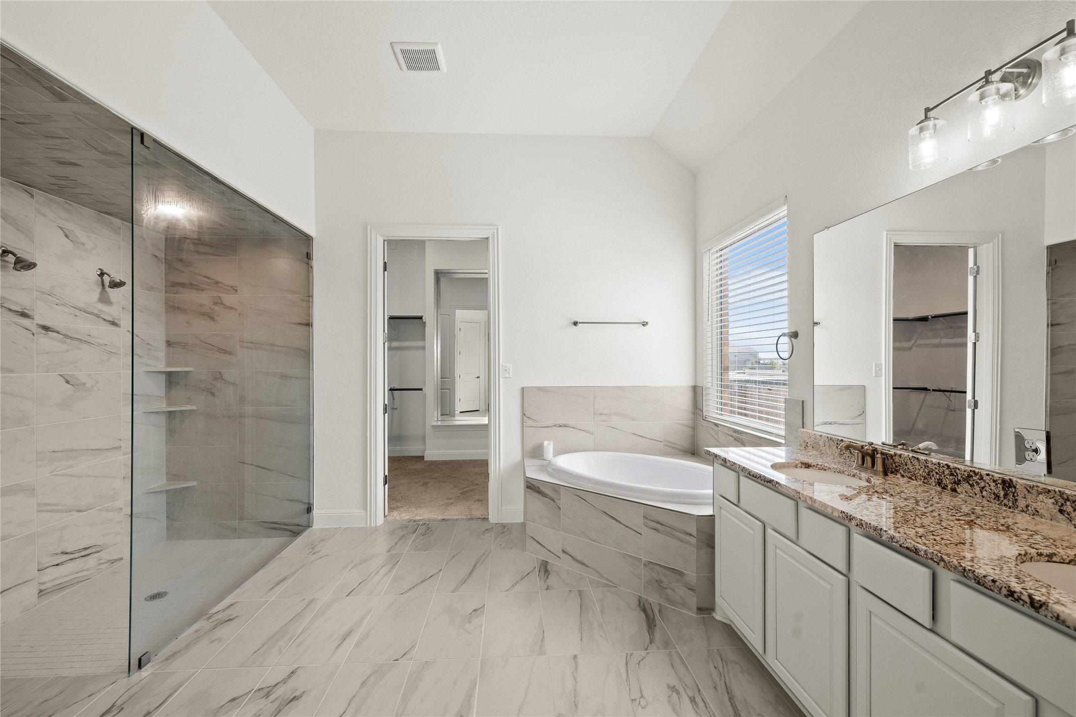 101 Bosco Road Hutto, TX 78634 - Photo 19 of 34 a bathroom with a double vanity sink and a mirror
