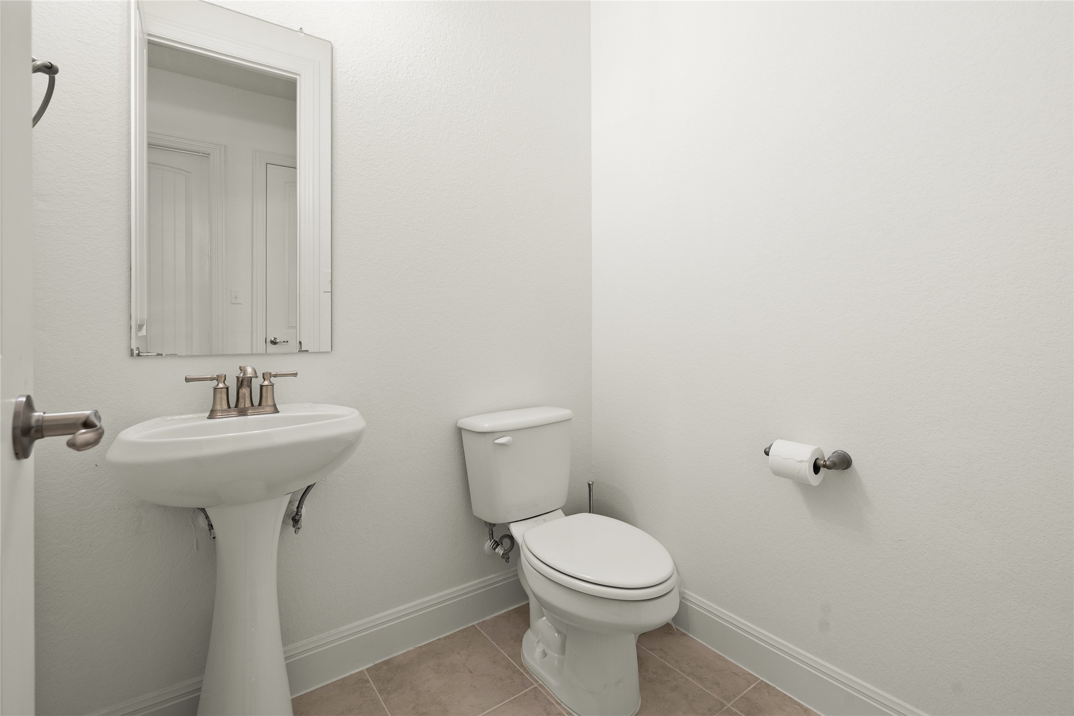 101 Bosco Road Hutto, TX 78634 - Photo 27 of 34 a bathroom with a sink a toilet and mirror