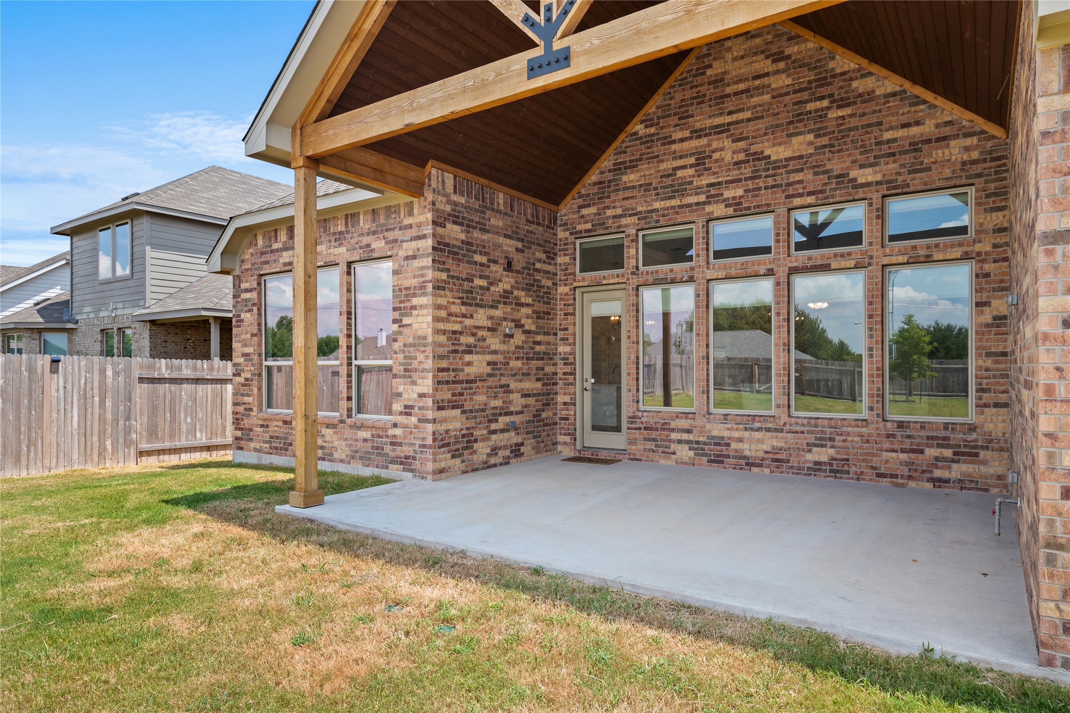 101 Bosco Road Hutto, TX 78634 - Photo 29 of 34 a porch with a table and chairs next to a yard