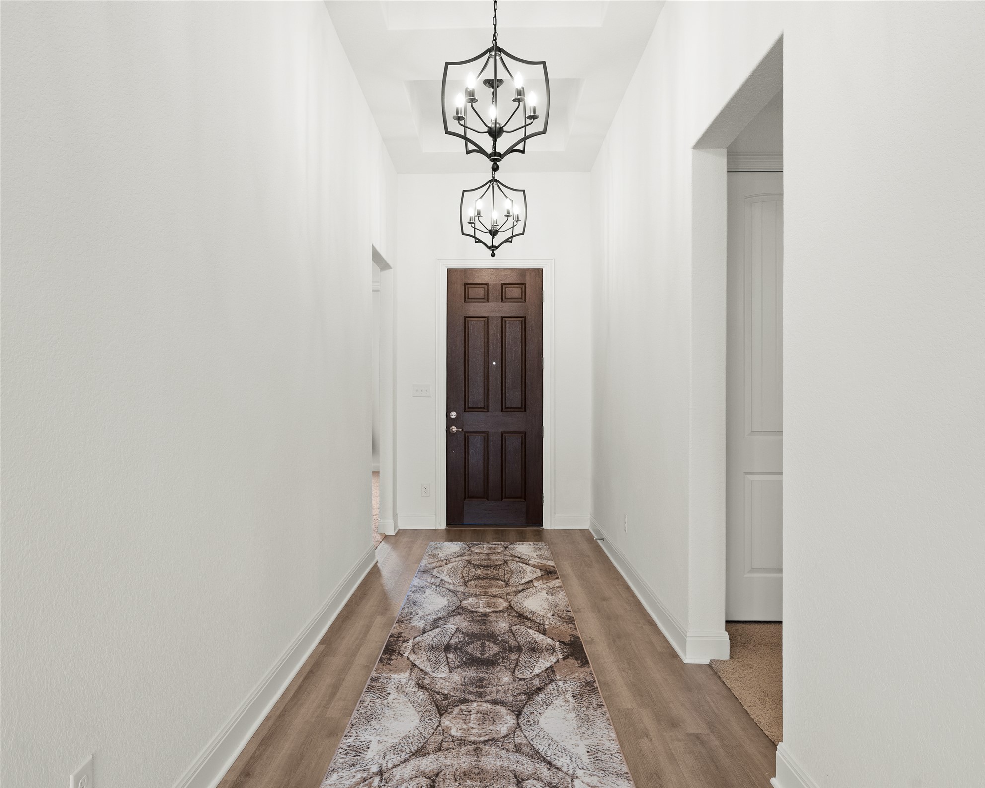 101 Bosco Road Hutto, TX 78634 - Photo 5 of 34 a view of a hallway with wooden floor