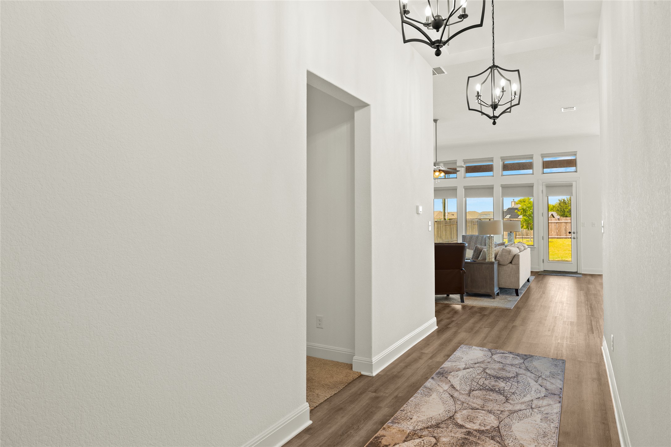 101 Bosco Road Hutto, TX 78634 - Photo 6 of 34 a hallway with a chandelier