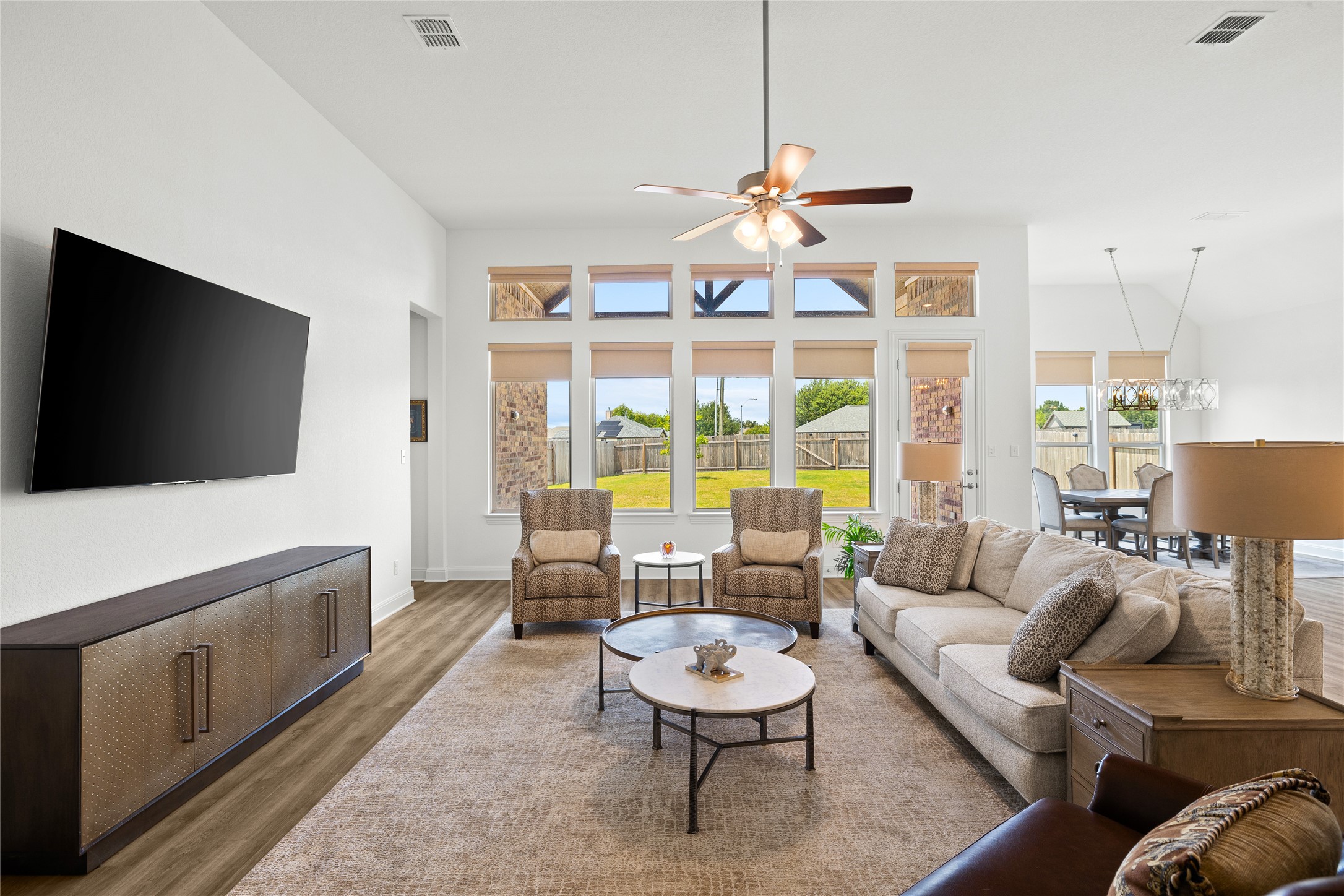 101 Bosco Road Hutto, TX 78634 - Photo 8 of 34 a living room with furniture a flat screen tv and a large window