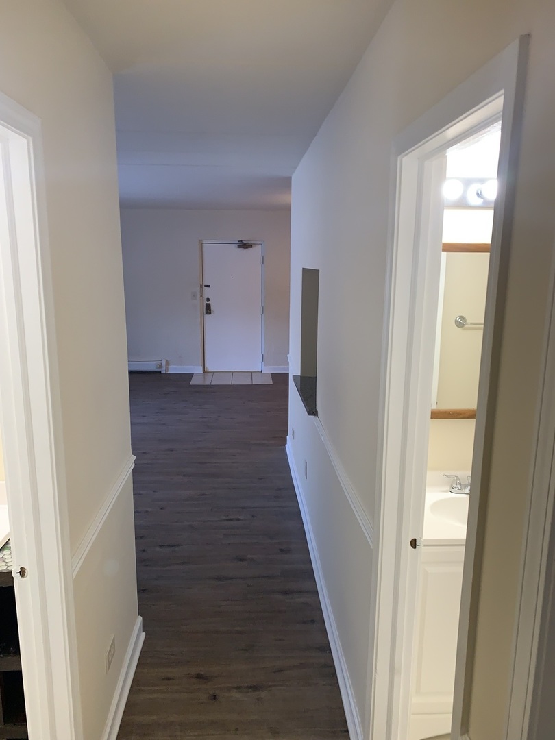 264 East Bailey Road, Unit C Naperville, IL 60565 - Photo 11 of 30 a view of a hallway with wooden floor and staircase
