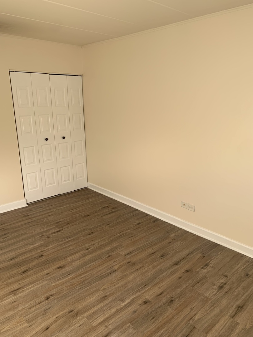 264 East Bailey Road, Unit C Naperville, IL 60565 - Photo 13 of 30 a view of an empty room with wooden floor