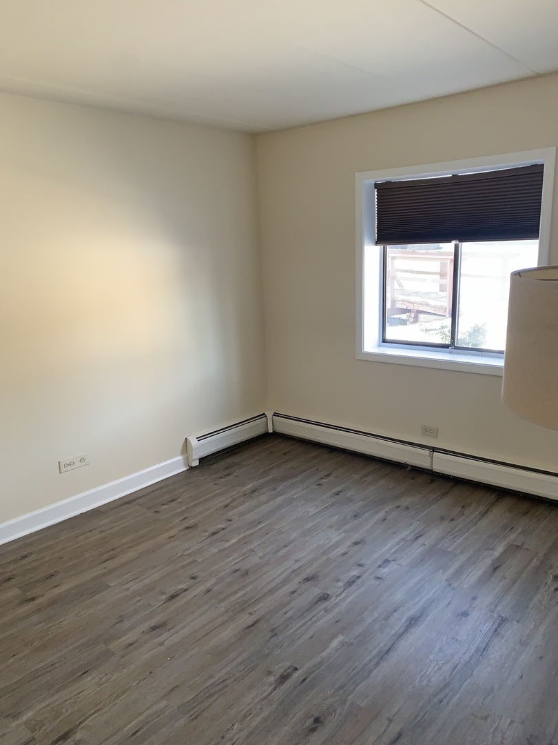 264 East Bailey Road, Unit C Naperville, IL 60565 - Photo 14 of 30 an empty room with wooden floor and a window