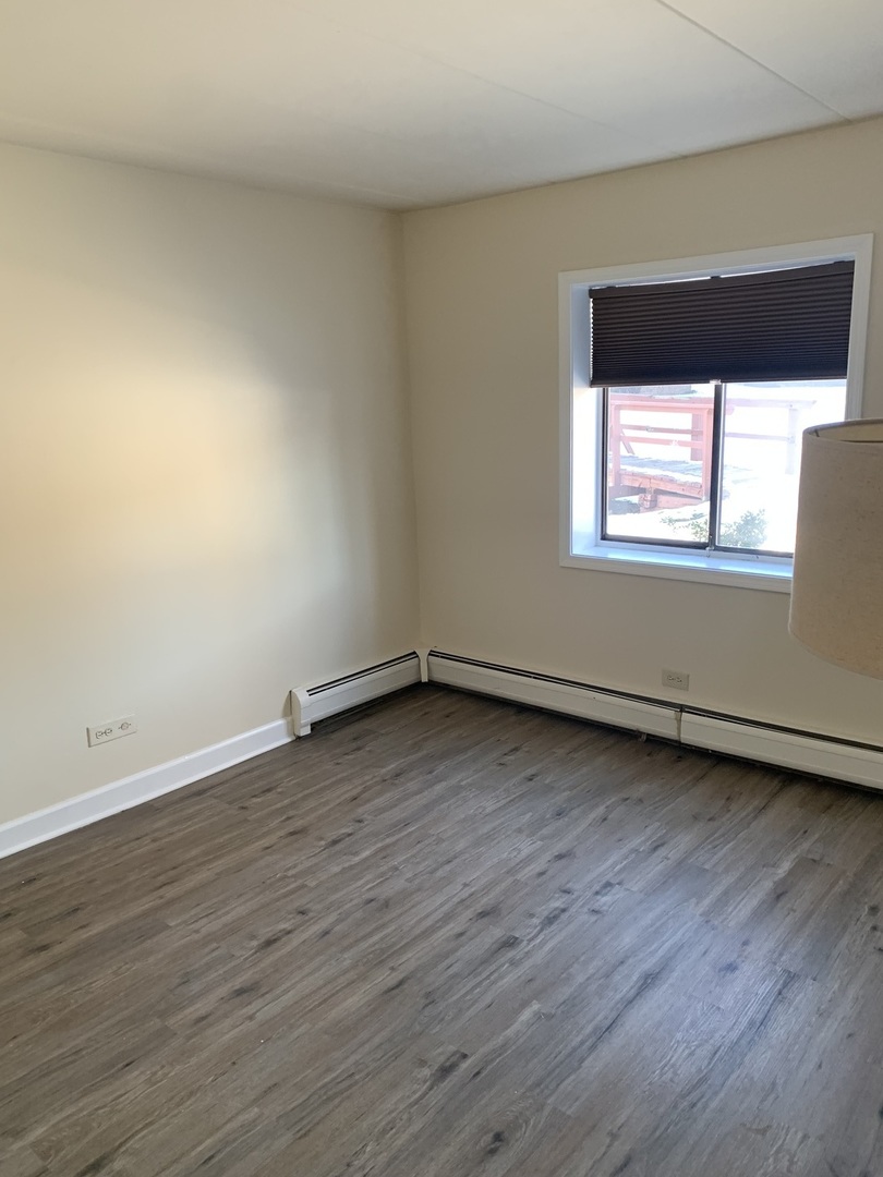 264 East Bailey Road, Unit C Naperville, IL 60565 - Photo 15 of 30 an empty room with wooden floor and windows