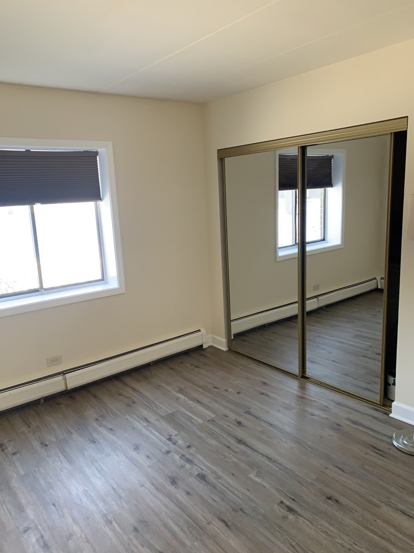264 East Bailey Road, Unit C Naperville, IL 60565 - Photo 17 of 30 an empty room with wooden floor and windows