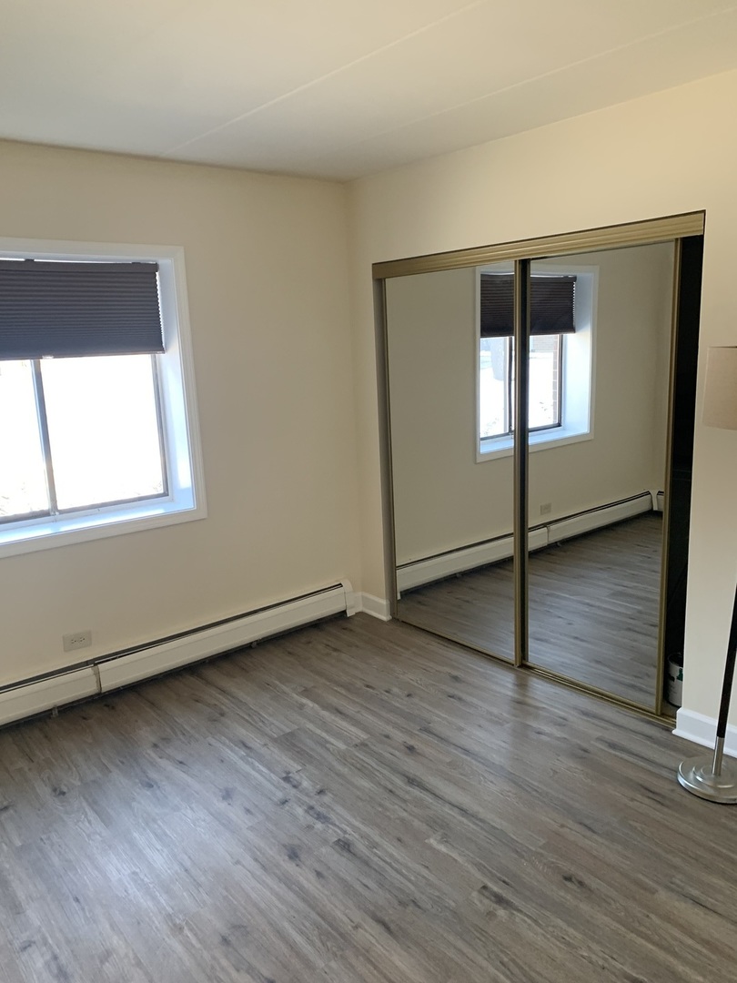 264 East Bailey Road, Unit C Naperville, IL 60565 - Photo 18 of 30 an empty room with wooden floor and windows