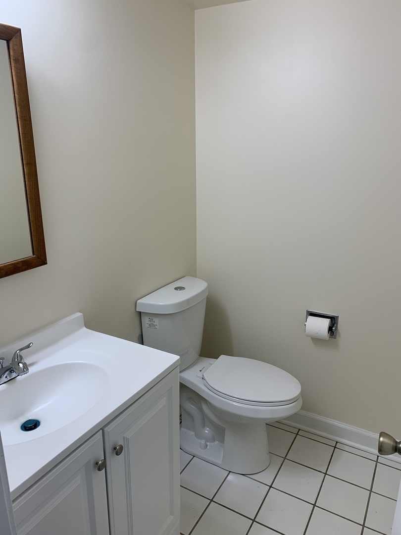 264 East Bailey Road, Unit C Naperville, IL 60565 - Photo 20 of 30 a bathroom with a sink toilet and mirror
