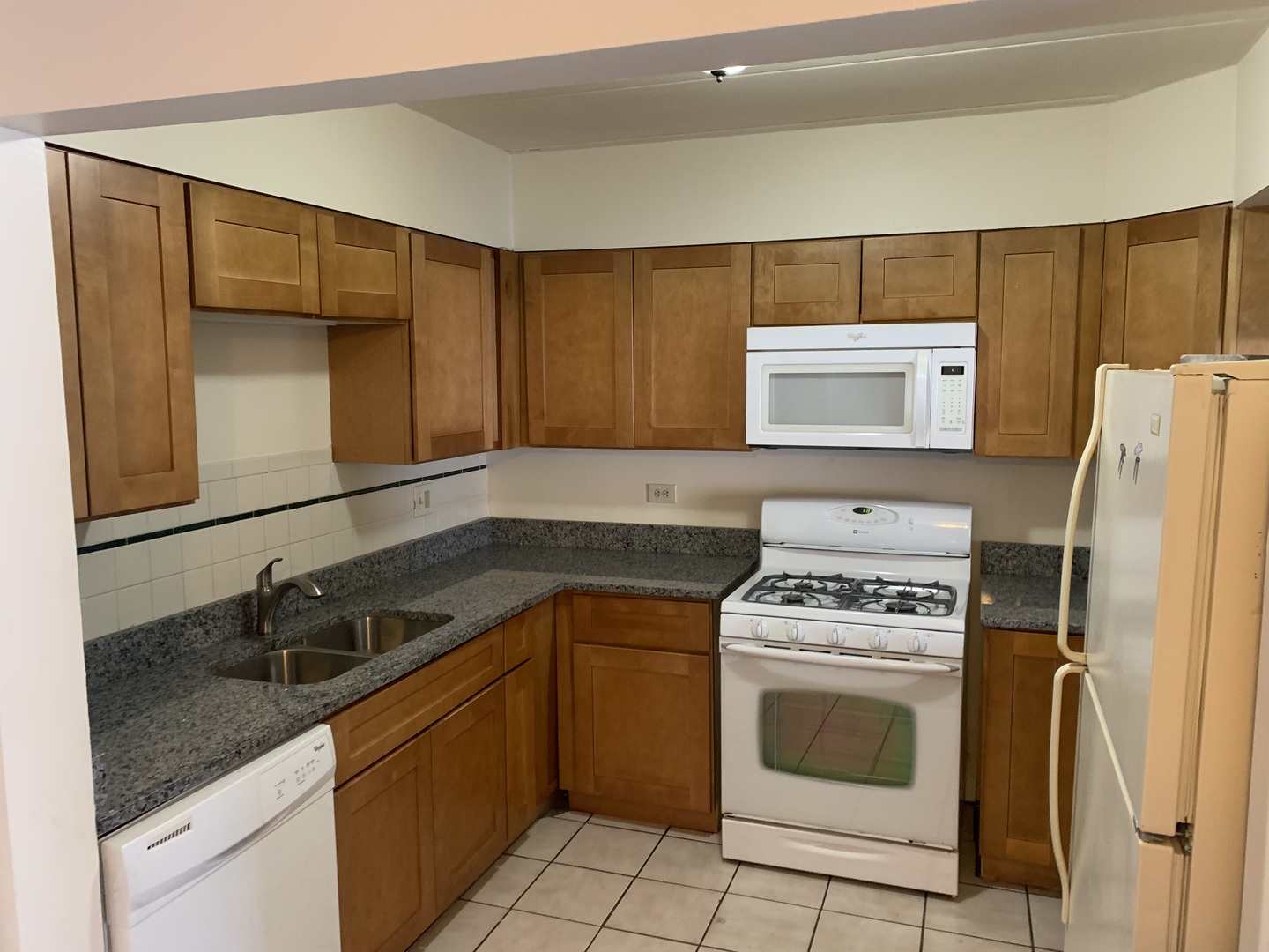 264 East Bailey Road, Unit C Naperville, IL 60565 - Photo 9 of 30 a kitchen with a refrigerator sink and stove