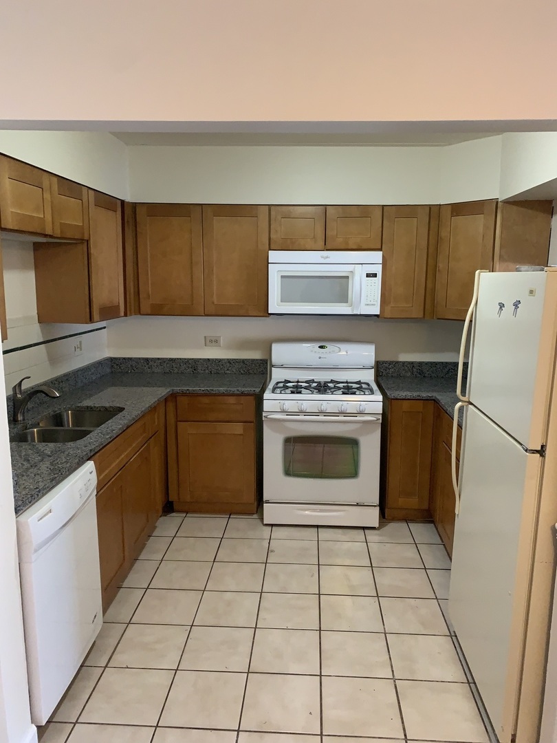 264 East Bailey Road, Unit C Naperville, IL 60565 - Photo 10 of 30 a kitchen with a stove top oven cabinets and stainless steel appliances
