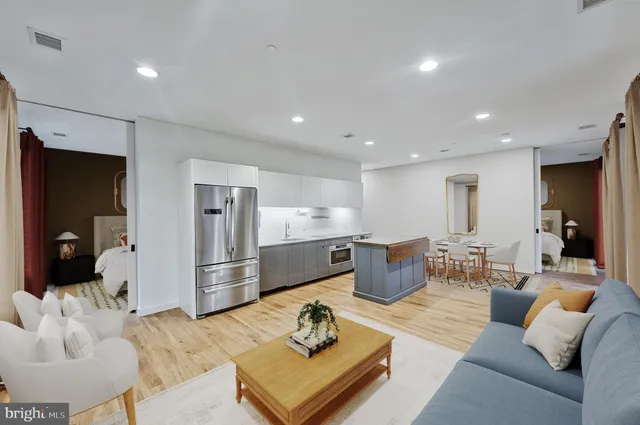a kitchen with stainless steel appliances granite countertop a refrigerator and a sink