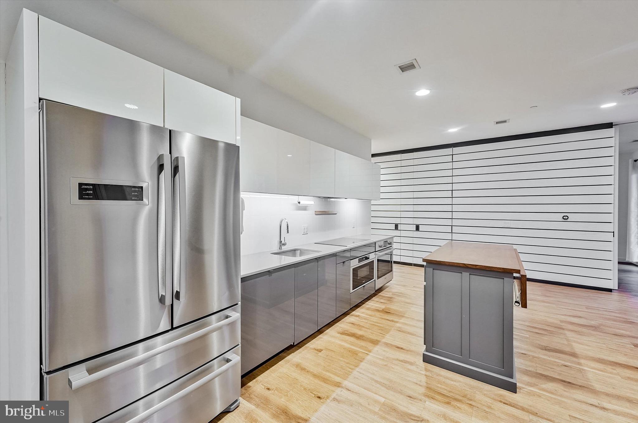 57 N Street Northwest, Unit 125 Washington, DC 20001 - Photo 15 of 56 a kitchen with stainless steel appliances granite countertop a refrigerator and a sink