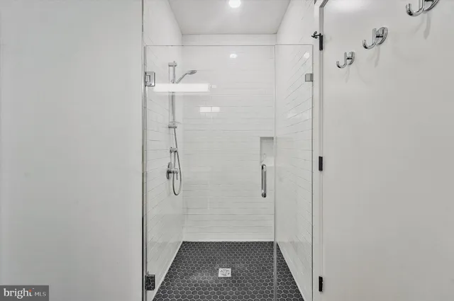 a view of a house with a large window and flower plants