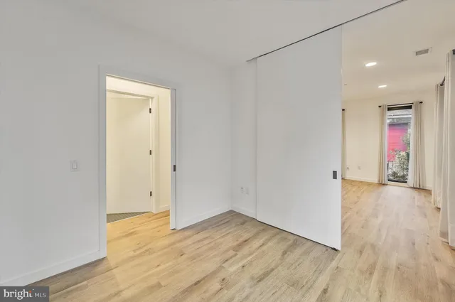 a balcony with couple of cars parked in front of it