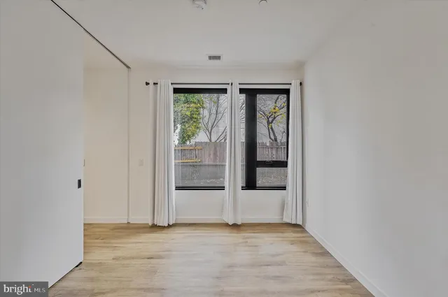 a living room with furniture and large windows
