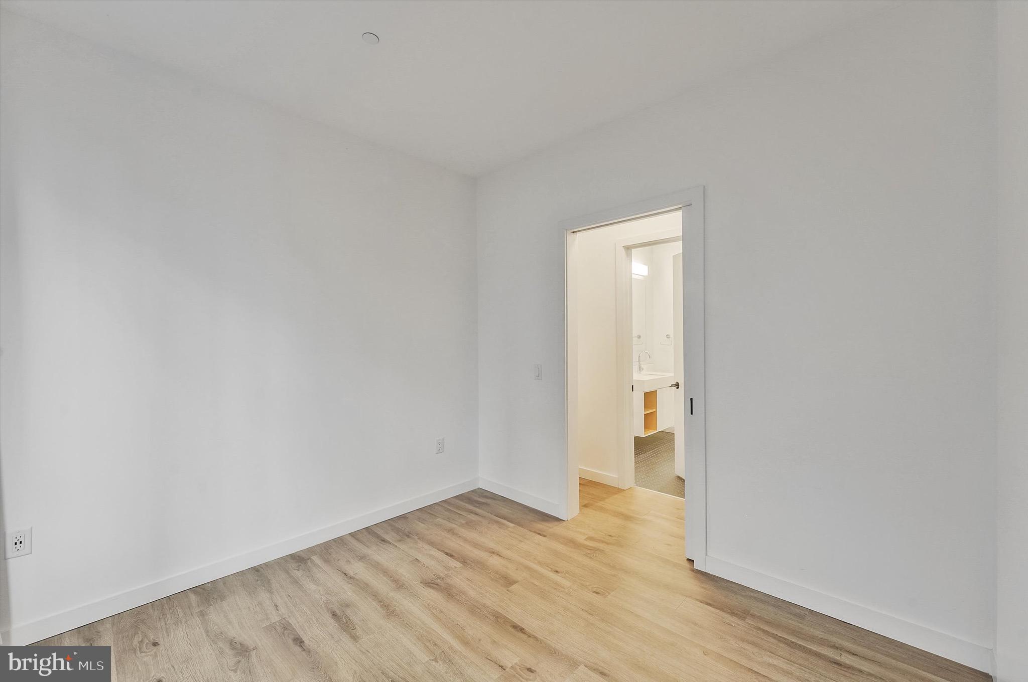 57 N Street Northwest, Unit 125 Washington, DC 20001 - Photo 28 of 56 a view of an empty room with wooden floor and a window