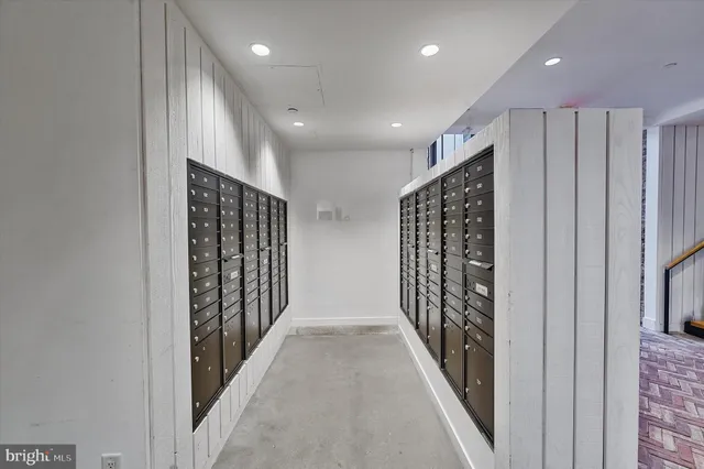 a view of an empty room with glass door and windows