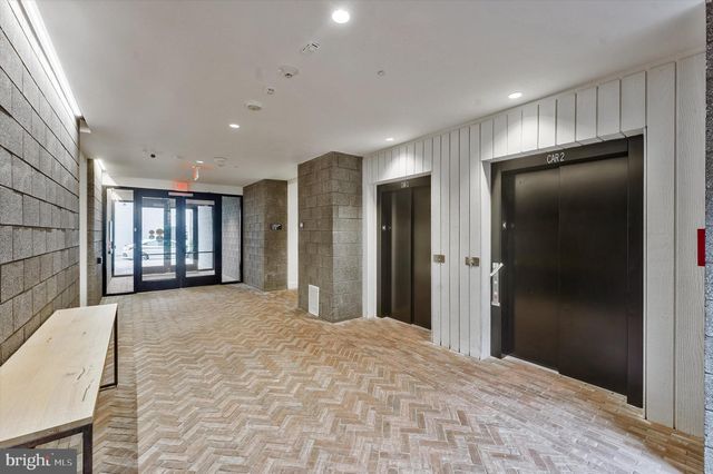 a view of an empty room and wooden floor