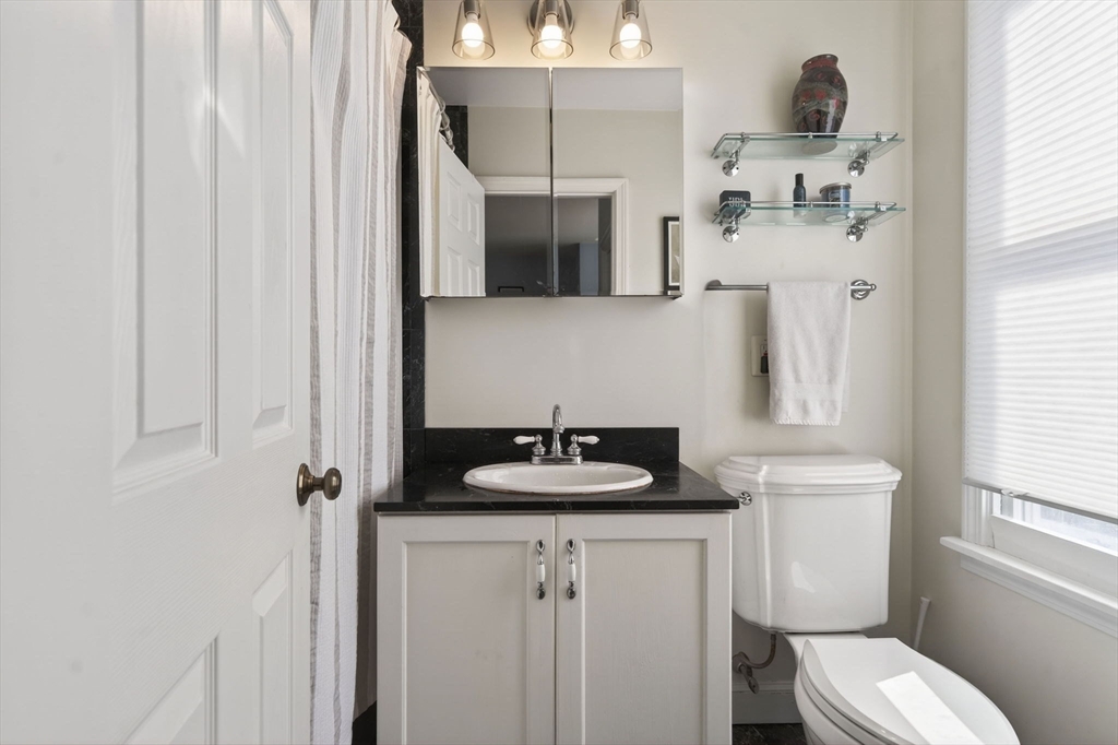 60 Rutland Street, Unit 4 Boston, MA 02118 - Photo 11 of 15 a bathroom with a sink toilet and mirror