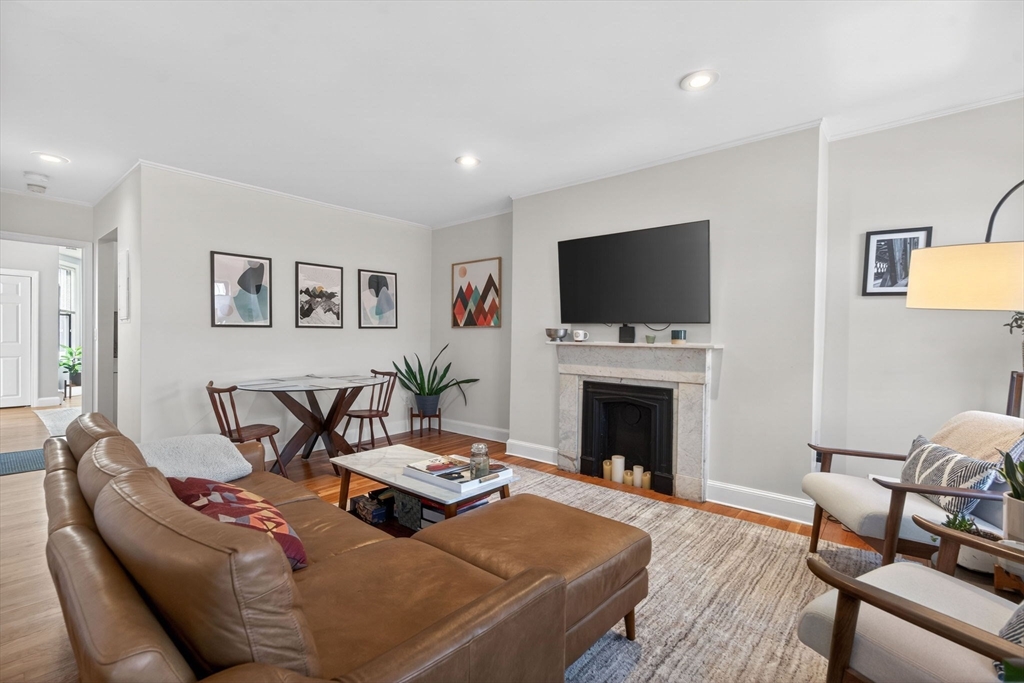 60 Rutland Street, Unit 4 Boston, MA 02118 - Photo 3 of 15 a living room with furniture a fireplace and a flat screen tv