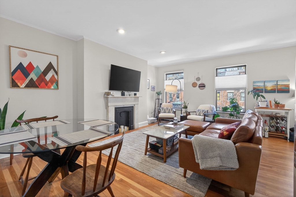 60 Rutland Street, Unit 4 Boston, MA 02118 - Photo 4 of 15 a living room with furniture a flat screen tv and a fireplace