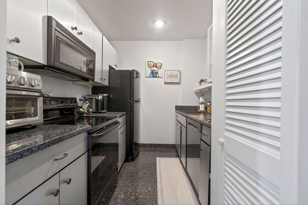 60 Rutland Street, Unit 4 Boston, MA 02118 - Photo 6 of 15 a kitchen with stainless steel appliances granite countertop a refrigerator and a stove top oven