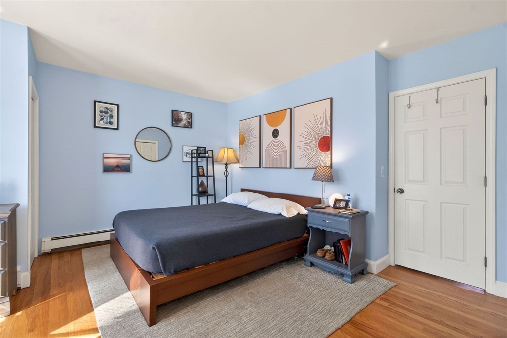 60 Rutland Street, Unit 4 Boston, MA 02118 - Photo 9 of 15 a bedroom with a bed and a chandelier