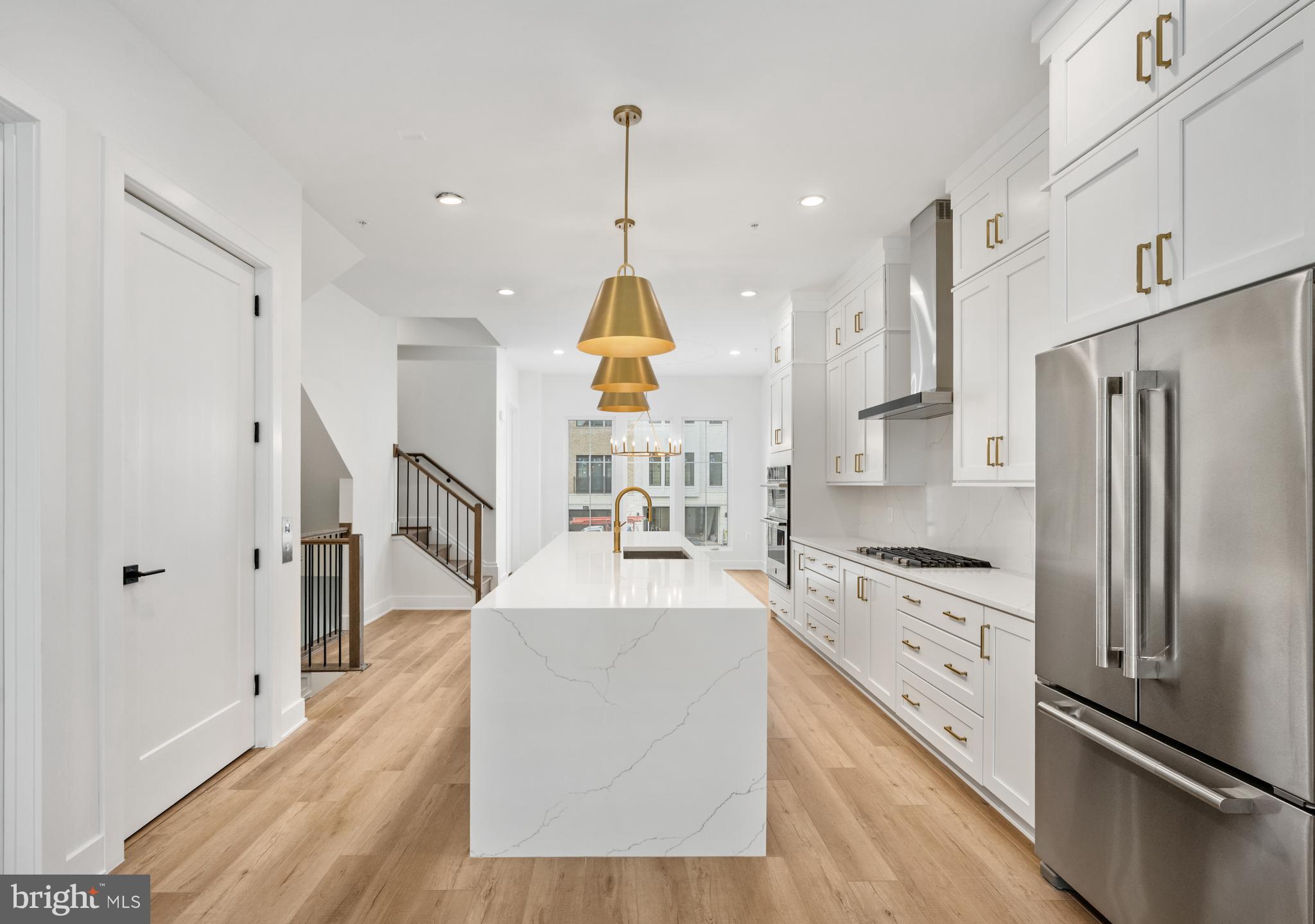 8610 Erdem Place Chevy Chase, MD 20815 - Photo 2 of 21 a kitchen with stainless steel appliances kitchen island granite countertop a refrigerator a sink dishwasher and a stove with wooden floor